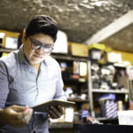 Businessman working using tablet in a auto repair shop